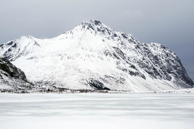 Scenic view of snow covered mountains against sky