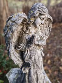 Close-up of angel statue in cemetery