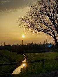 Scenic view of river against sky during sunset