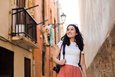 Portrait of smiling young woman standing outdoors