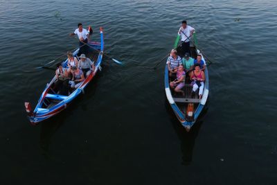 High angle view of men on boat moored in water