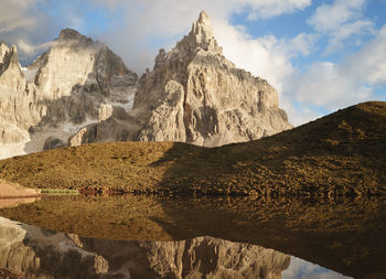 Low angle view of rocky mountains against sky