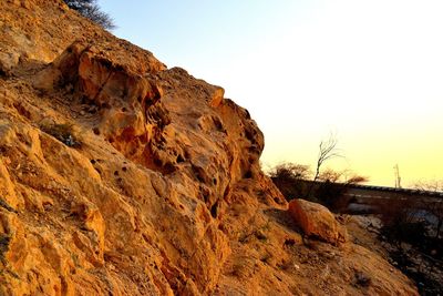 Rock formations on landscape against clear sky