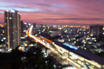 High angle view of city lit up at night