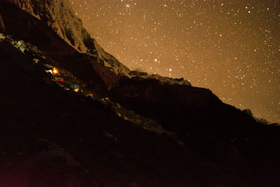 Scenic view of mountain against sky at night