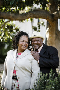 Portrait of happy senior couple standing at park