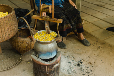 Low section of person standing on wicker basket