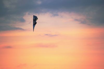 Silhouette of person paragliding against sky