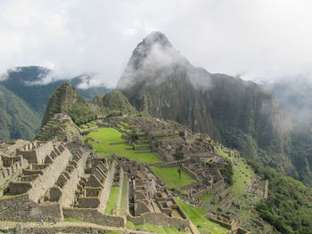 Magnificient view of machu picchu with some clouds above 