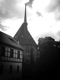 Low angle view of building against cloudy sky