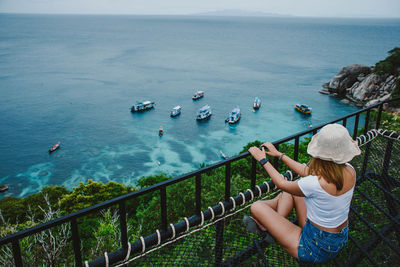 High angle view of woman standing by sea