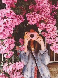 Full length of woman with pink flowers