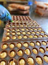High angle view of hand holding glass container