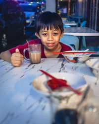 Portrait of girl painting on table