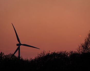 Silhouette of wind turbines at sunset