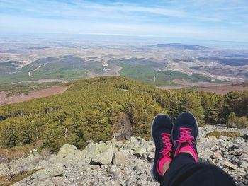 Low section of person on landscape against mountains
