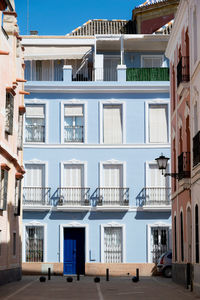 Residential buildings against blue sky