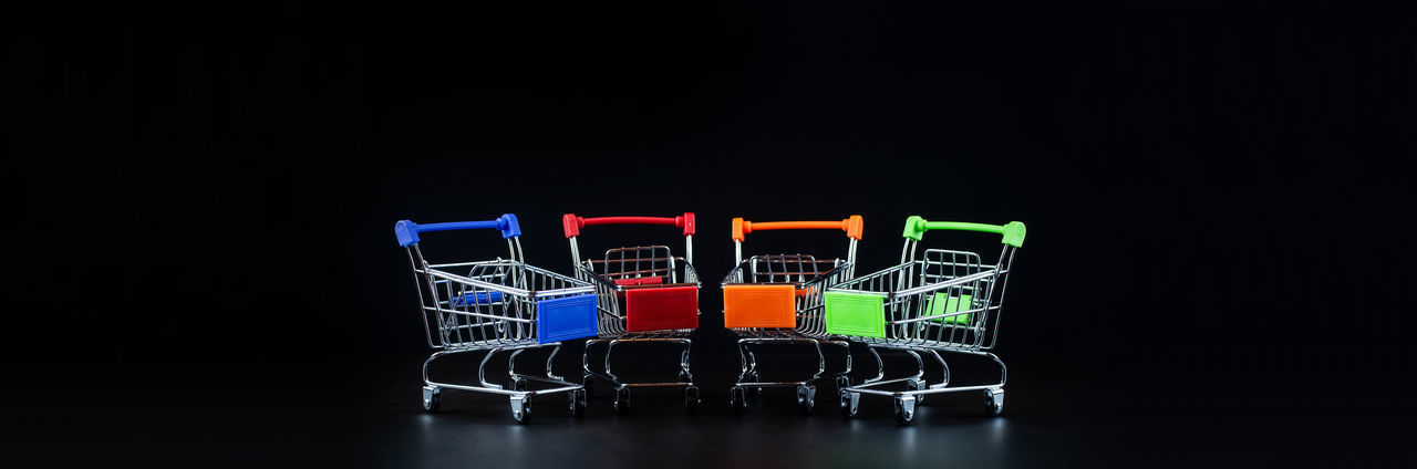 CLOSE-UP OF COLORED PENCILS OVER BLACK BACKGROUND