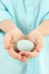 Midsection of woman holding egg