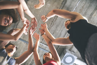 Group of young people huddling in gym