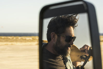 Portrait of man wearing sunglasses against sky