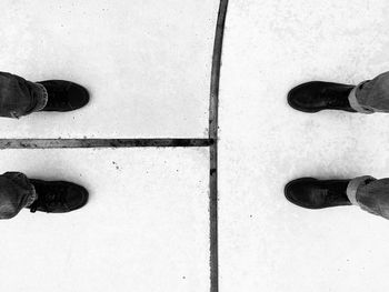 Low section of man standing on tiled floor