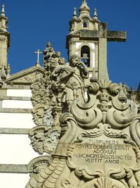 Low angle view of statue against building against clear sky