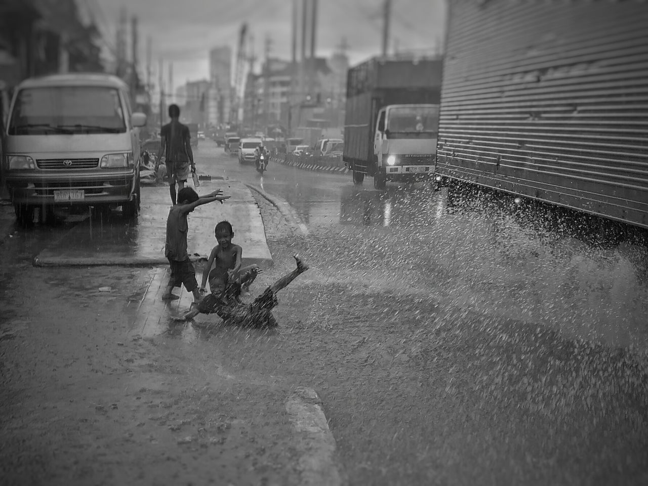 PEOPLE ON WET ROAD IN RAIN