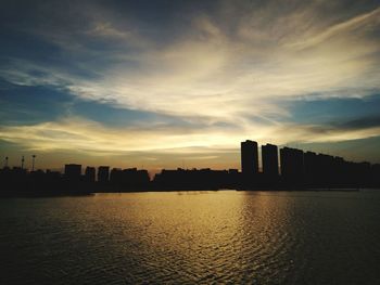 Scenic view of city against sky during sunset