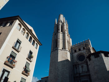 Low angle view of historical buildings against clear blue sky