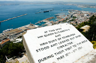 High angle view of text on sea against buildings in city