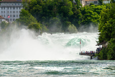 Waterfall on the river rhine in the city neuhausen am rheinfall in switzerland. tourists standing