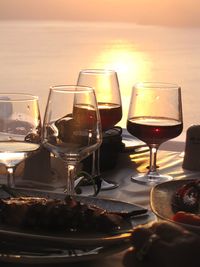 Food and drinks on restaurant table at sunset