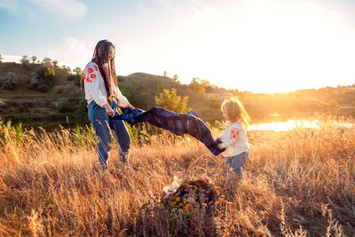 Global view, real life around the globe, local living. mom and daughter in national clothes and