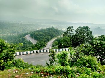 High angle view of tree on mountain by road against sky