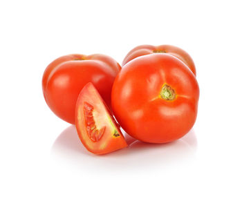 Close-up of tomatoes against white background