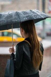 Woman with umbrella during rainy season