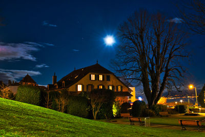 Illuminated buildings against sky at night