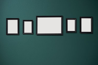 Empty picture frames hanging on wall in museum