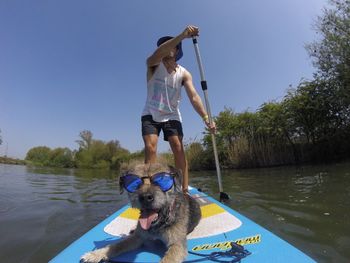 Man with dog standing in lake