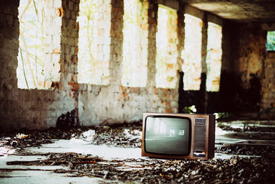 Old television set in abandoned house