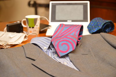 Close-up of suit and necktie on table