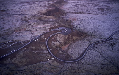 Curvy freeway among desert stony terrain