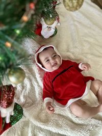 High angle view of cute baby girl sleeping on bed