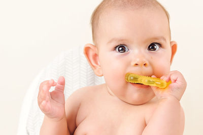 Portrait of cute baby girl eating