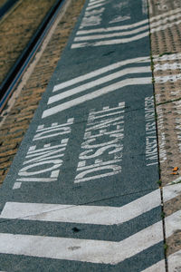 High angle view of arrow sign on road