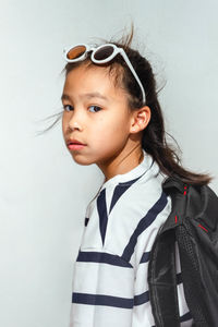 Young woman standing against wall