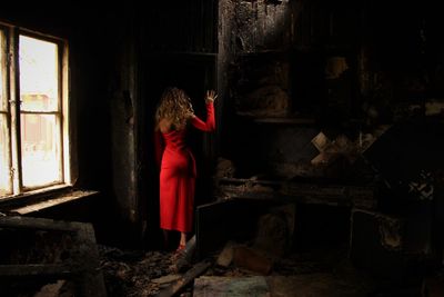 Full length rear view of woman in abandoned room