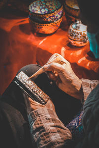 Cropped hand of woman holding food