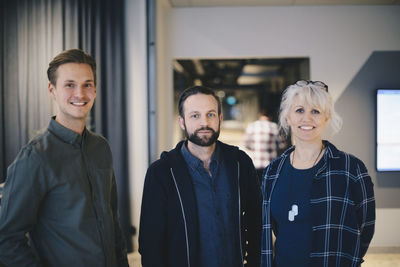 Portrait of confident business people standing together in office